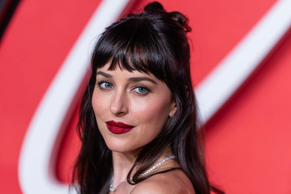 Dakota Johnson wears dark red lipstick.